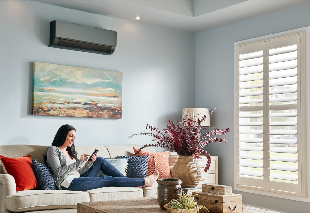 Woman in a stylish room. Learn about LG's flexible options that can optimize the environmental control system in your home.