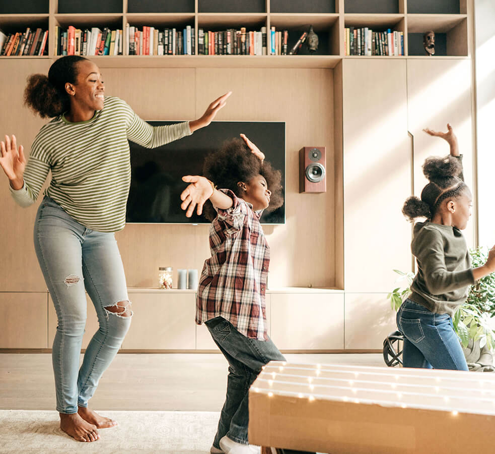 a mom and her children dancing in their living room